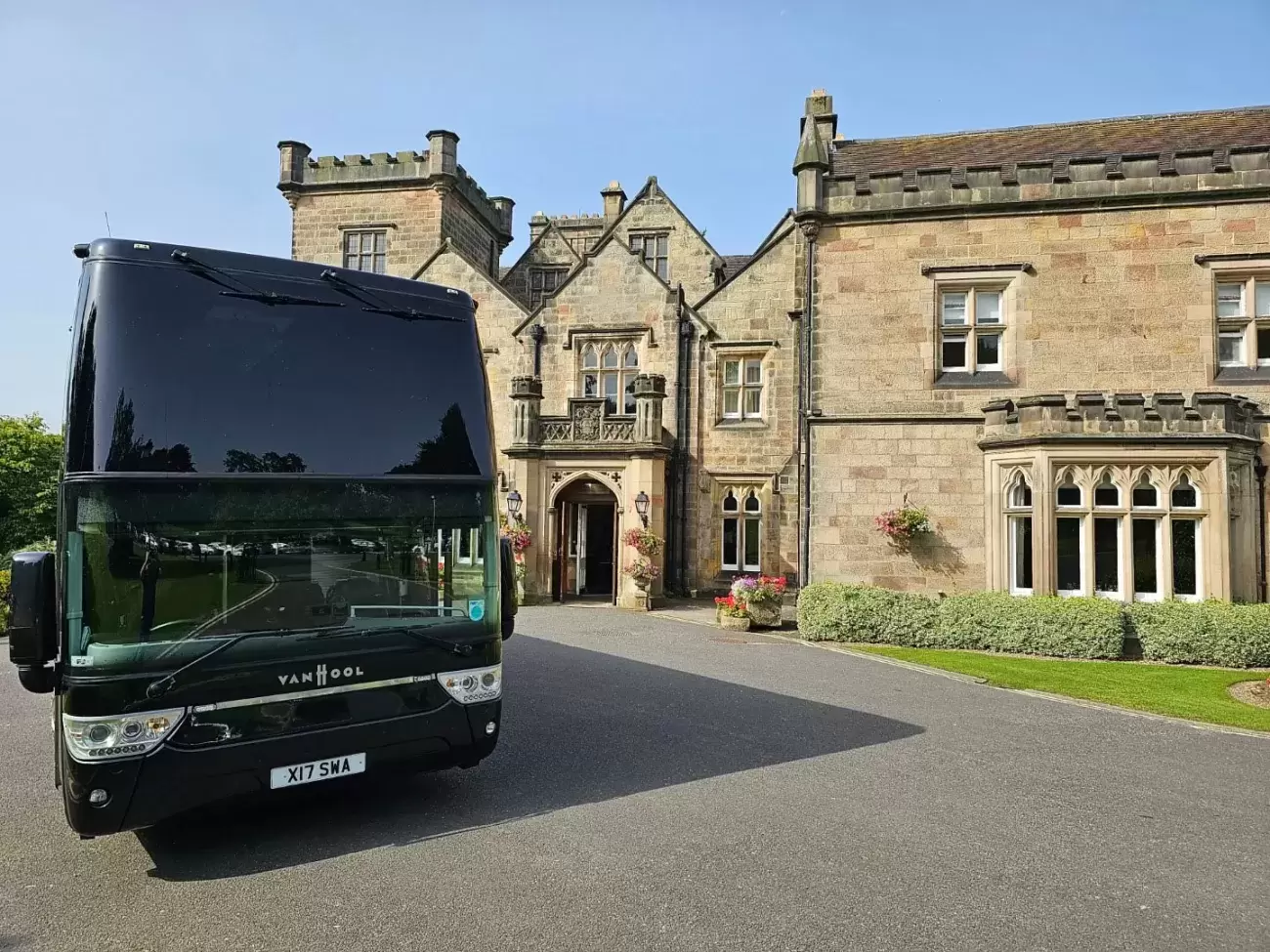 Coach outside stately home
